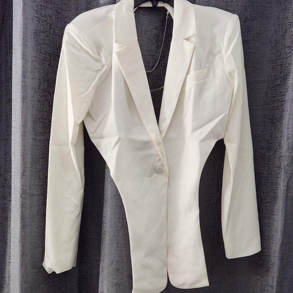 White blazer, open back,  chain detail.